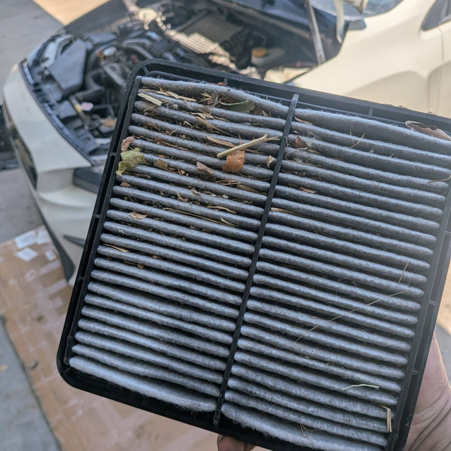 Dirty engine air filter removed during mobile maintenance service in Weld County